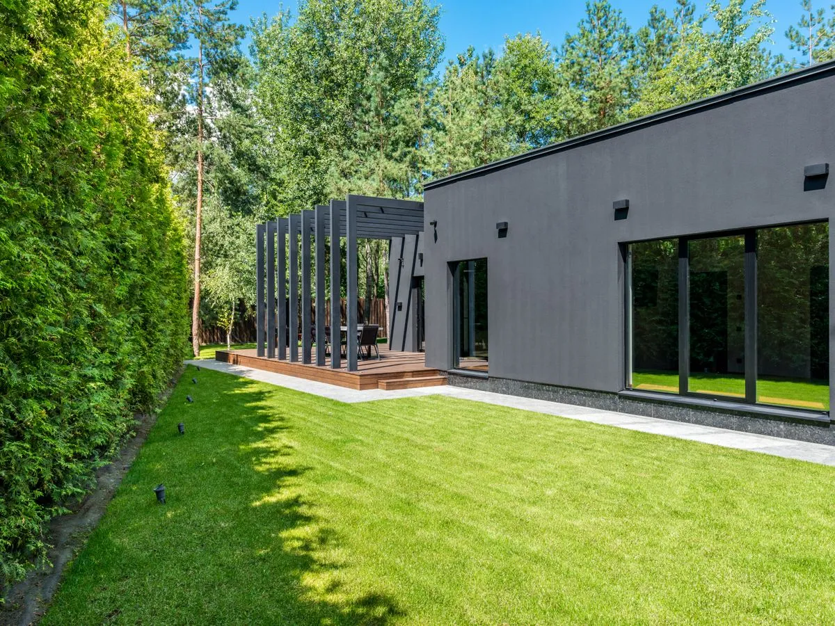 A landscaped garden with planting and a path beside a home